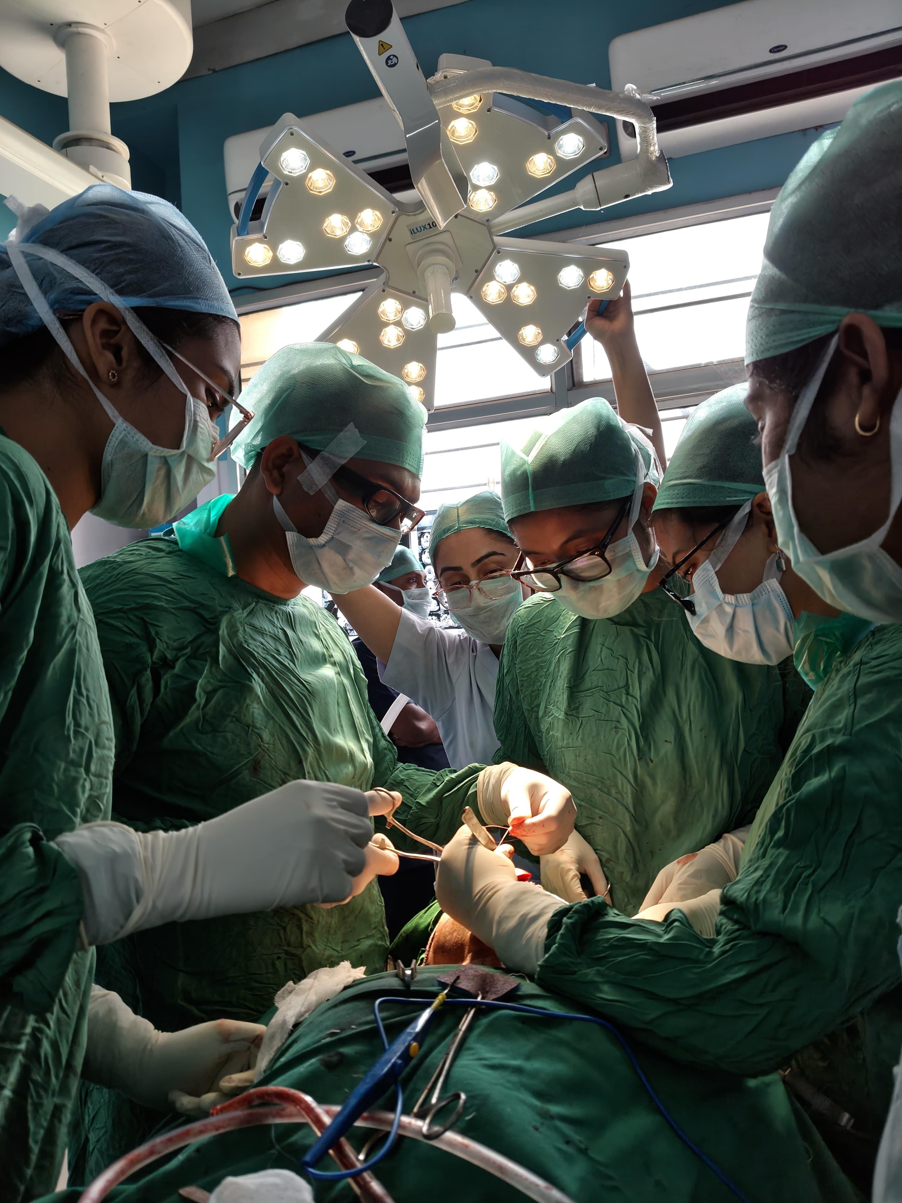 Surgical team collaborating under surgical operating lights